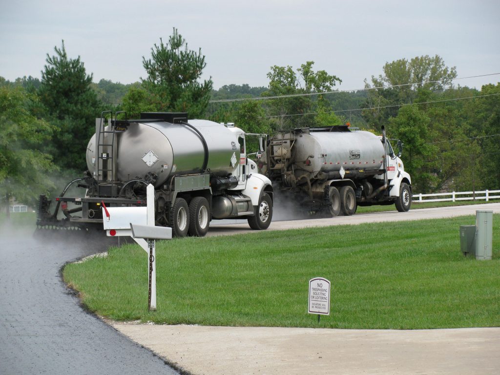 petroleum crew laying asphalt in residential neighborhood